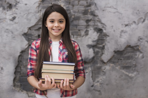 close-up-positive-young-girl-holding-pile-books_23-2148464493
